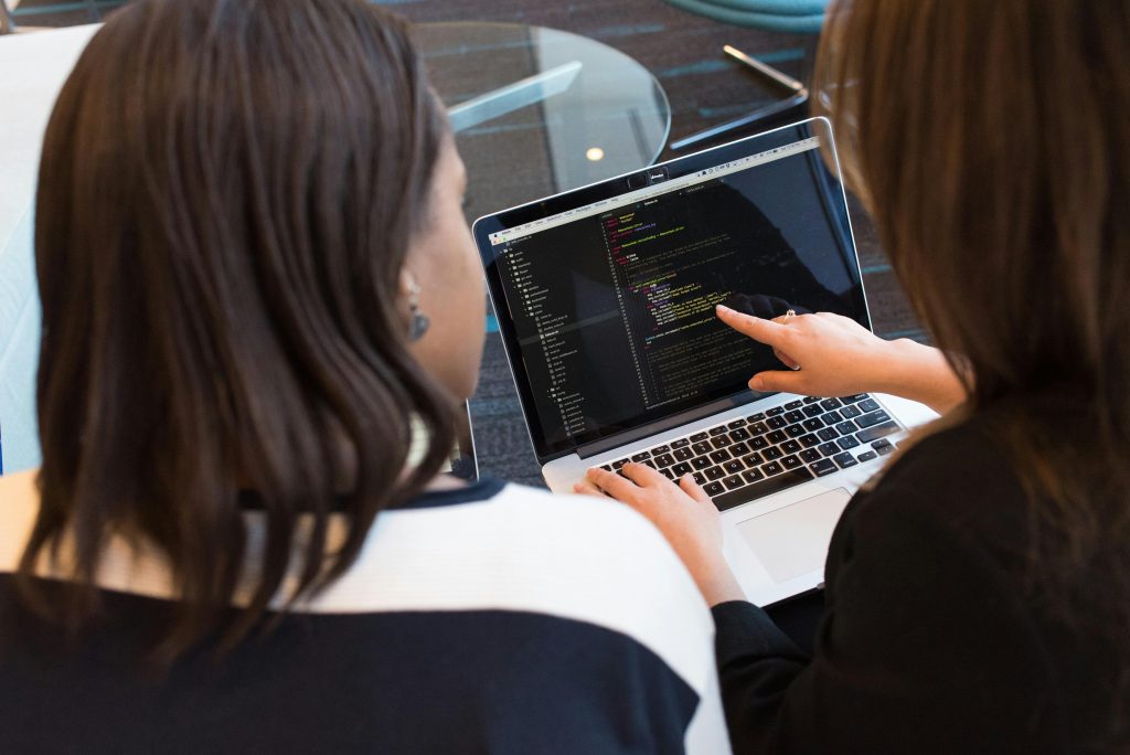 2 women going over code